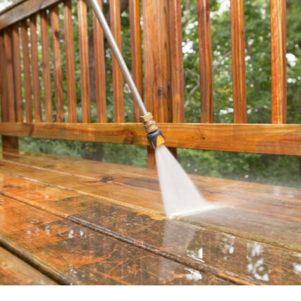 Paint Sprayers & Pressure WashersA pressure washer wand spraying a deck, revealing the clean, stained surface beneath the dirt.